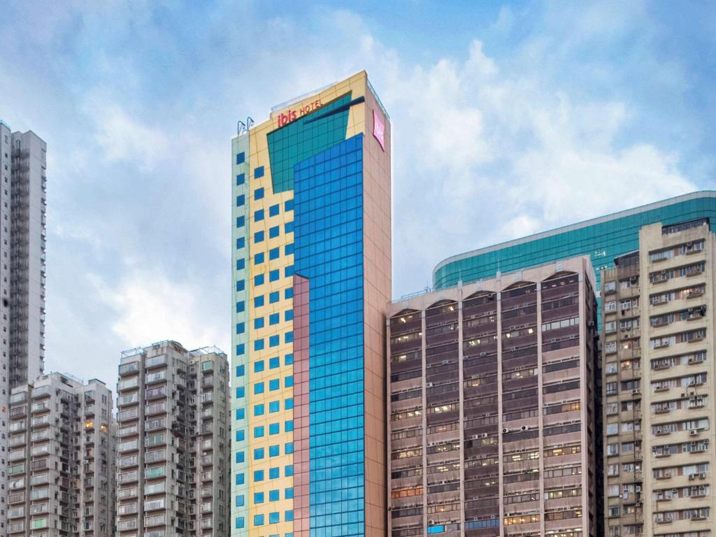 un edificio alto con ventanas azules en una ciudad en ibis Hong Kong North Point en Hong Kong