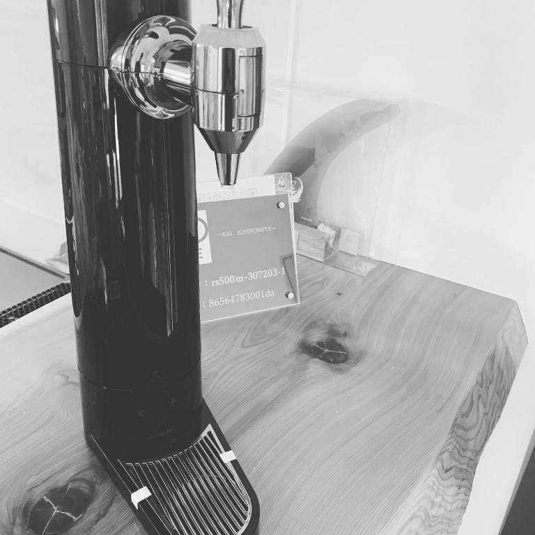 a black blender sitting on top of a wooden table at KAI Ichinomiya in Ichinomiya