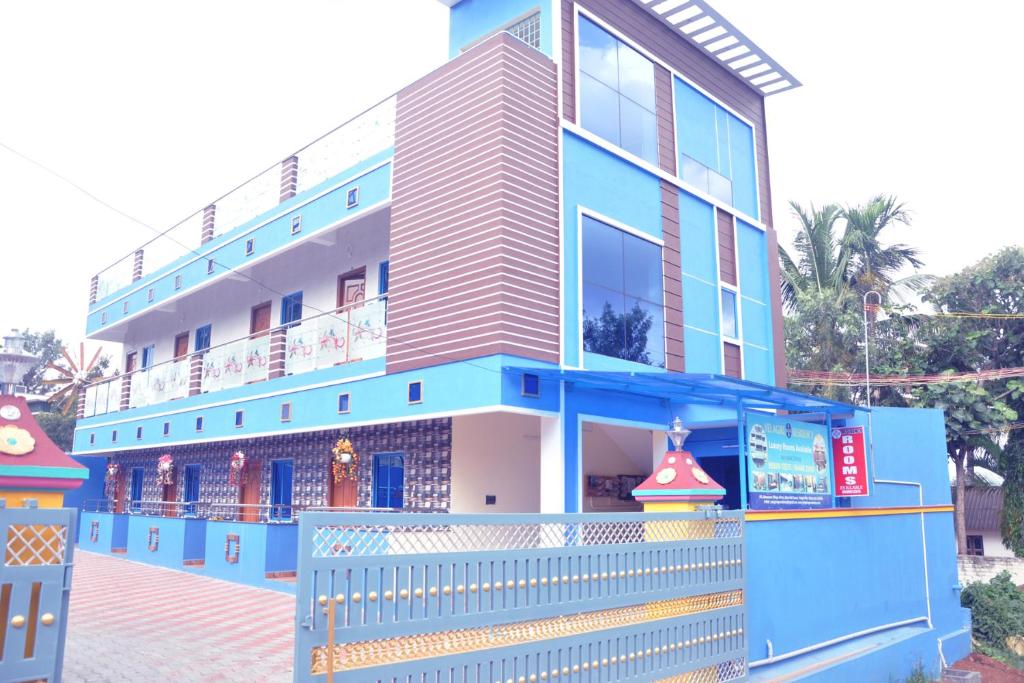 a blue building with a fence in front of it at Yelagiri EGV Residency in Yelagiri