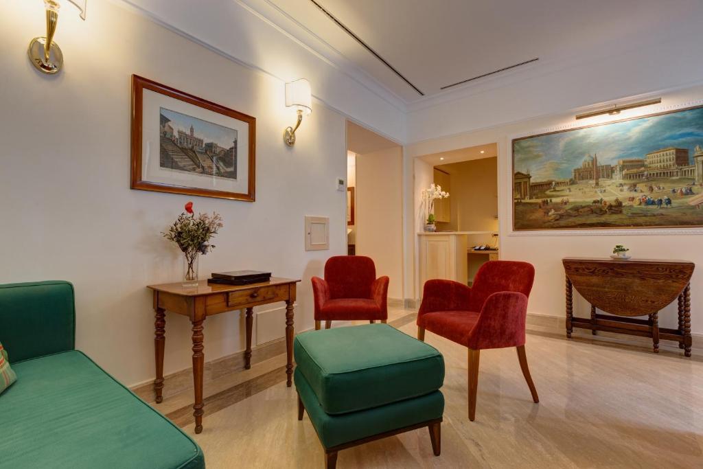 a living room with chairs and a table and a painting at Residenza RomaCentro in Rome