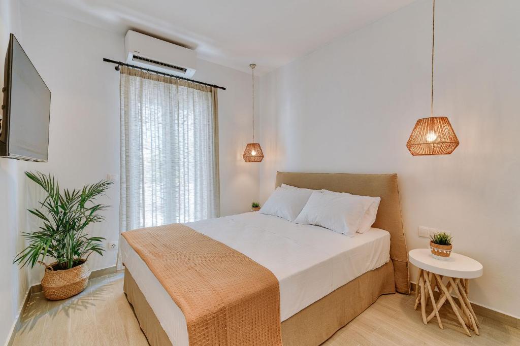 a bedroom with a bed and a window at Ardilia Cosy Apartments in Antiparos