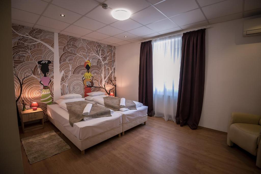 Postel nebo postele na pokoji v ubytování Mokka Apartman Szeged
