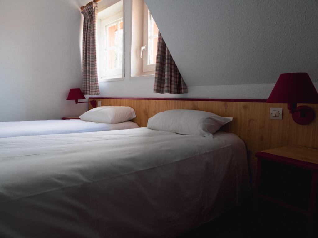 Postel nebo postele na pokoji v ubytování Les Loges de l'Ecomusée D'Alsace