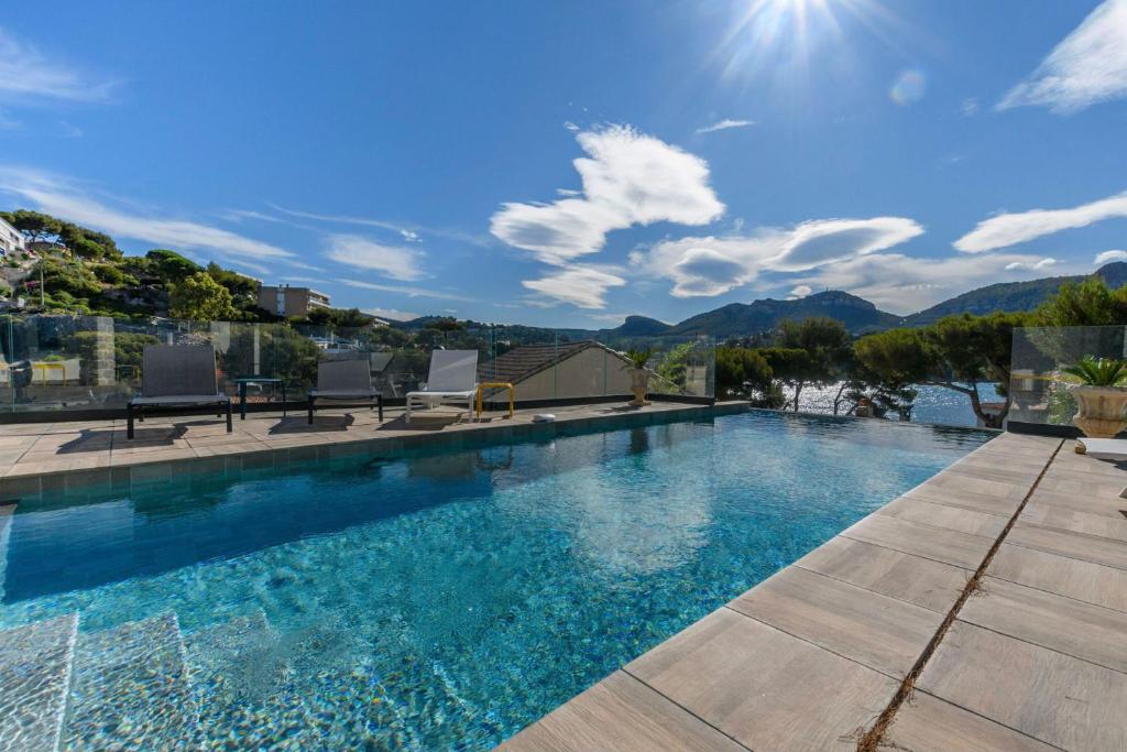 a swimming pool with a view of the mountains at Villa Talabar in Cassis