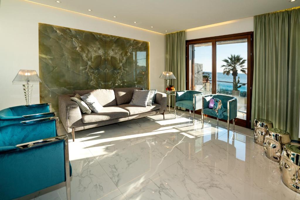 A seating area at Luxury Beachfront Apartment Taormina Pool and Parking