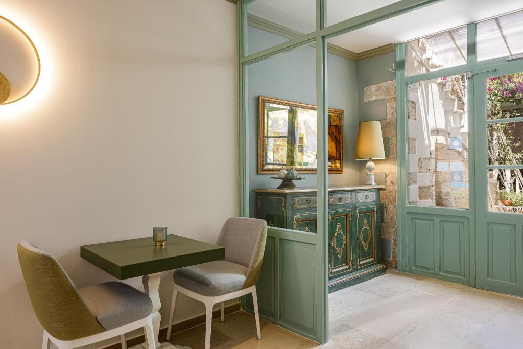 a dining room with a table and chairs at Mythos Suites Boutique Hotel in Rethymno