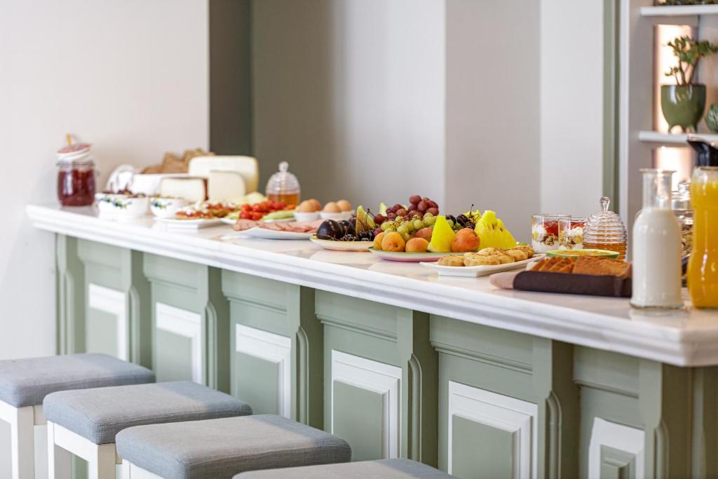 a buffet with several plates of food on a table at Mythos Suites Boutique Hotel in Rethymno