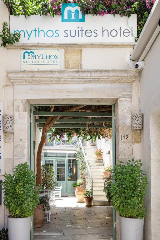 a entrance to a nursing suites hotel with potted plants at Mythos Suites Boutique Hotel in Rethymno