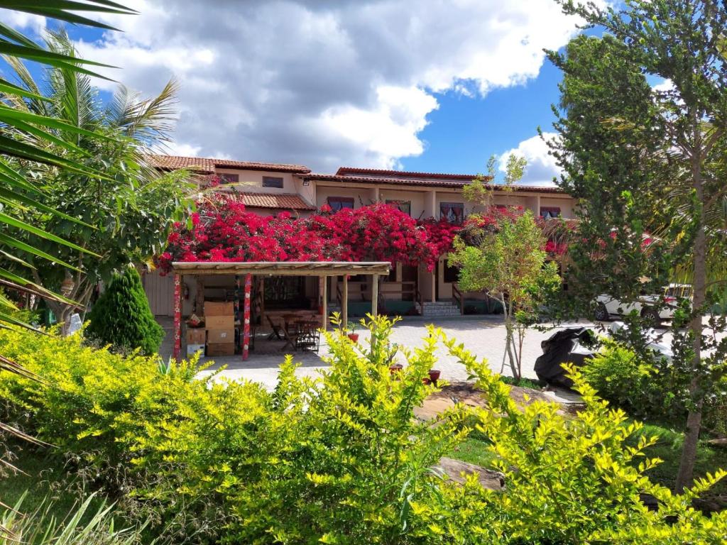 a building with pink flowers on the side of it at Pousada Primavera in Mucugê