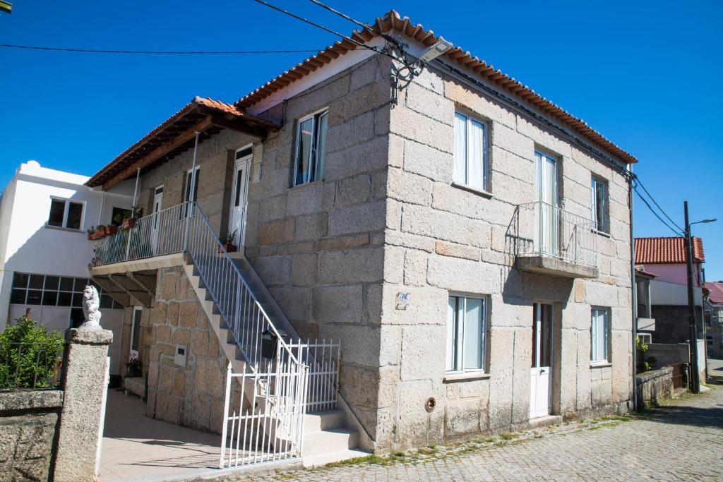 a stone house with a staircase in front of it at Recanto da Avó in Seia