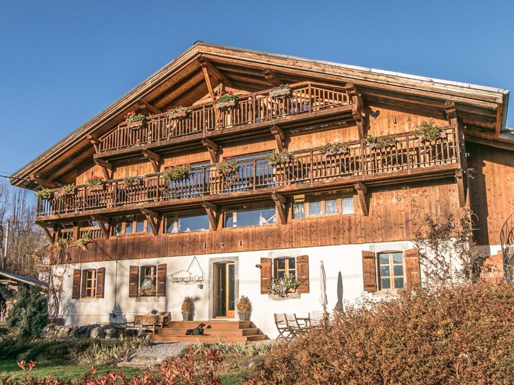 a large wooden house with a balcony on top of it at Ferme du Ciel in Samoëns