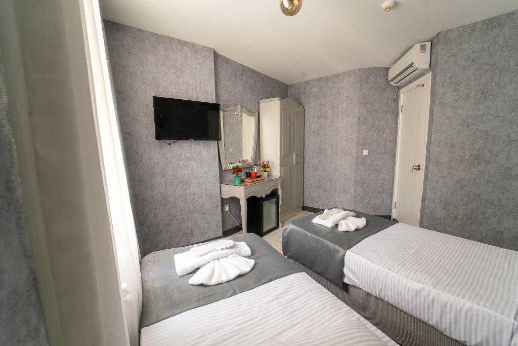 Postel nebo postele na pokoji v ubytování Old City Viva Hotel