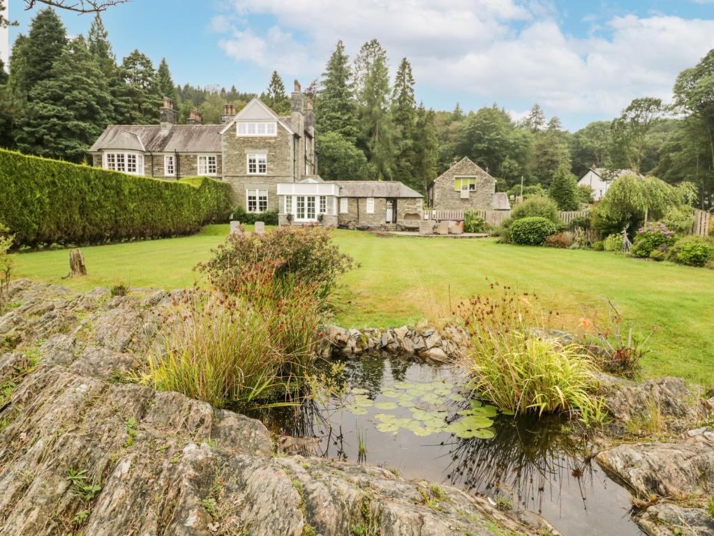 an exterior view of a large house with a yard at Deer Rise in Ulverston