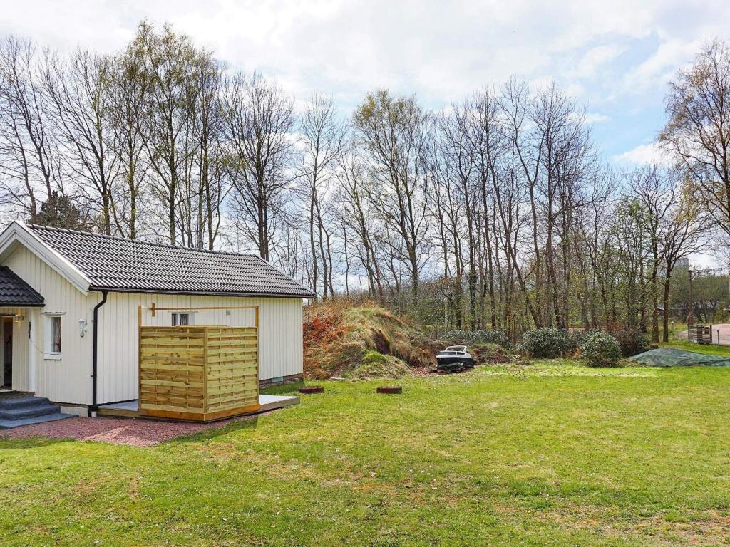 a small white house in a grassy yard at 4 person holiday home in LYSEKIL-By Traum in Lysekil