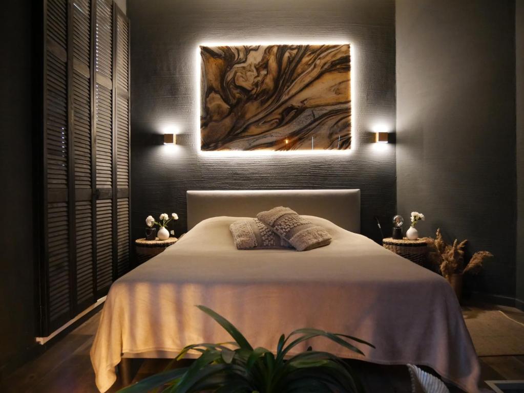 1 dormitorio con 1 cama con una pintura en la pared en SLEEP INN - Black and Gold Loft Antwerp Cityview, en Amberes