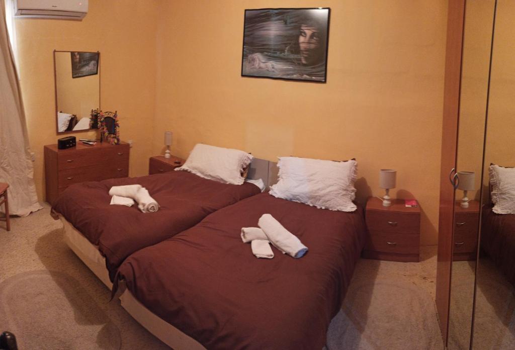 a bedroom with two beds with towels on them at IL bejta in Qrendi