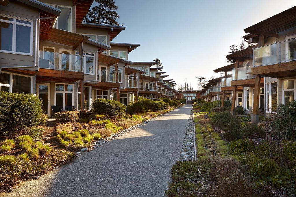 an empty street in front of some apartment buildings at Cox Bay Beach Resort in Tofino