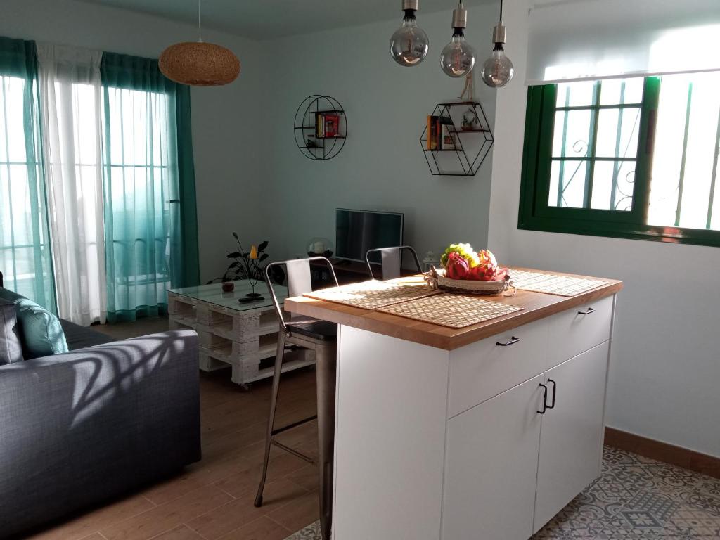 a living room with a kitchen with a counter top at Apartamento Maresia in Puerto del Carmen