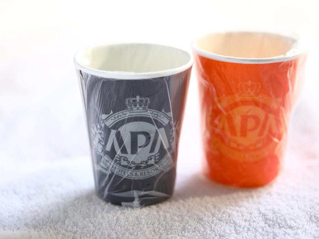 two cups sitting next to each other on the floor at APA Hotel Kintetsu Nara Ekimae in Nara