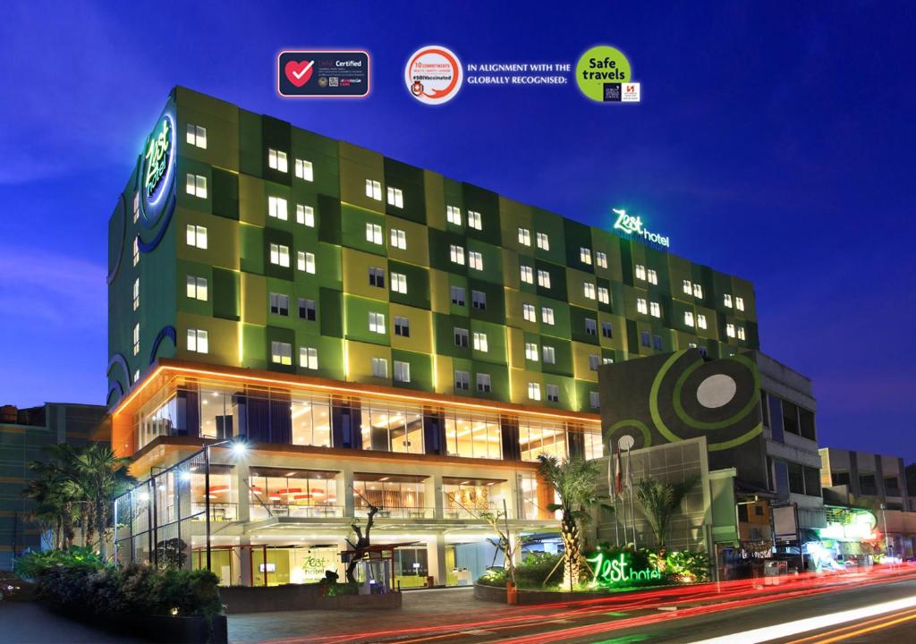 a large hotel building with a street in front of it at Zest Sukajadi Bandung by Swiss-Belhotel International in Bandung