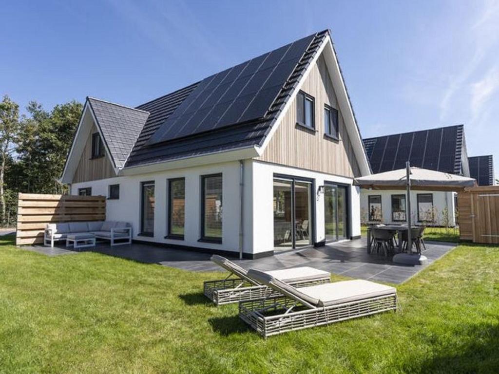 a house with solar panels on top of it at Attractive Holiday Home in De Koog Texel with Terrace in Westermient