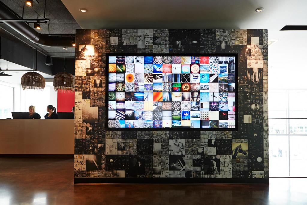 a wall with a large screen in a room at Alt Hotel Halifax Airport in Enfield