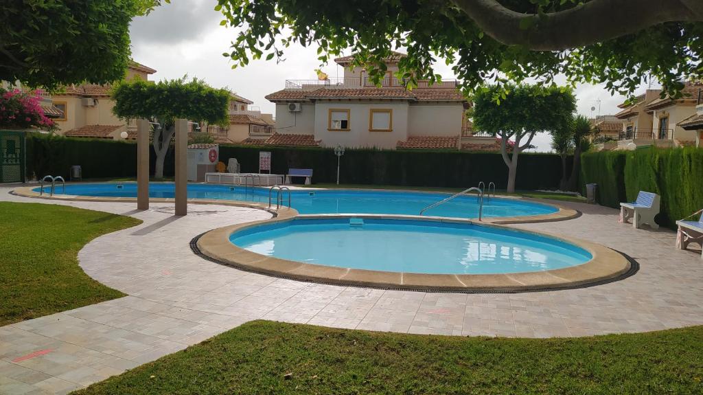 a swimming pool in the middle of a yard at LA CAMPANA in Orihuela Costa