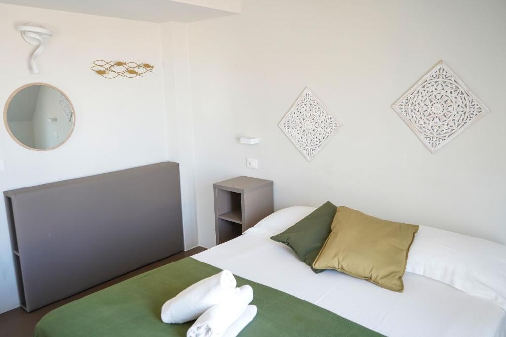 Postel nebo postele na pokoji v ubytování Hotel Rex