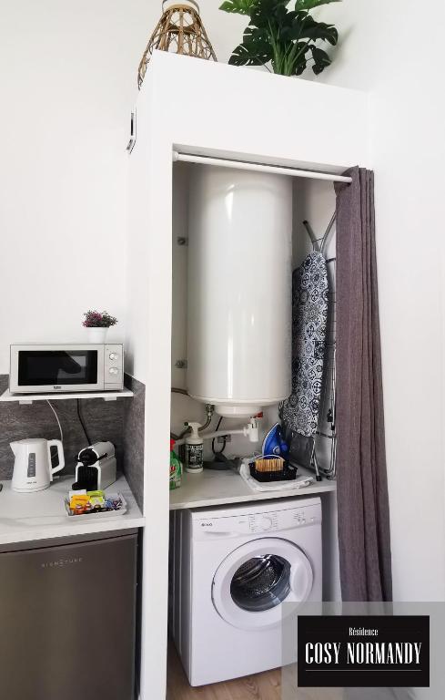 a kitchen with a washing machine and a microwave at Cosy Normandy - 03 in Bois-Jérôme-Saint-Ouen