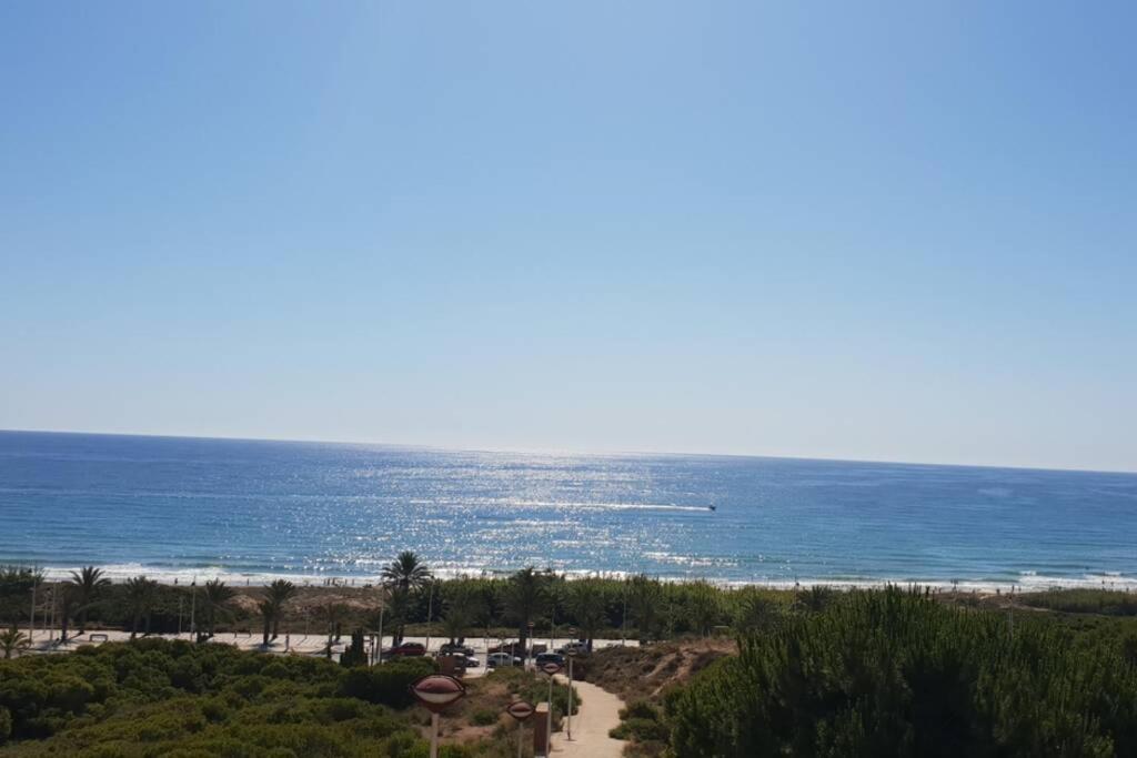 a view of the ocean from a resort at Apartamento muy cerca del mar. in Arenales del Sol