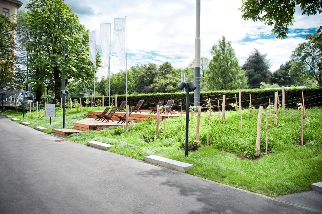 a park with benches and tables on the side of a road at Hotel Daniel Vienna - Smart Lifestyle Near City Centre in Vienna