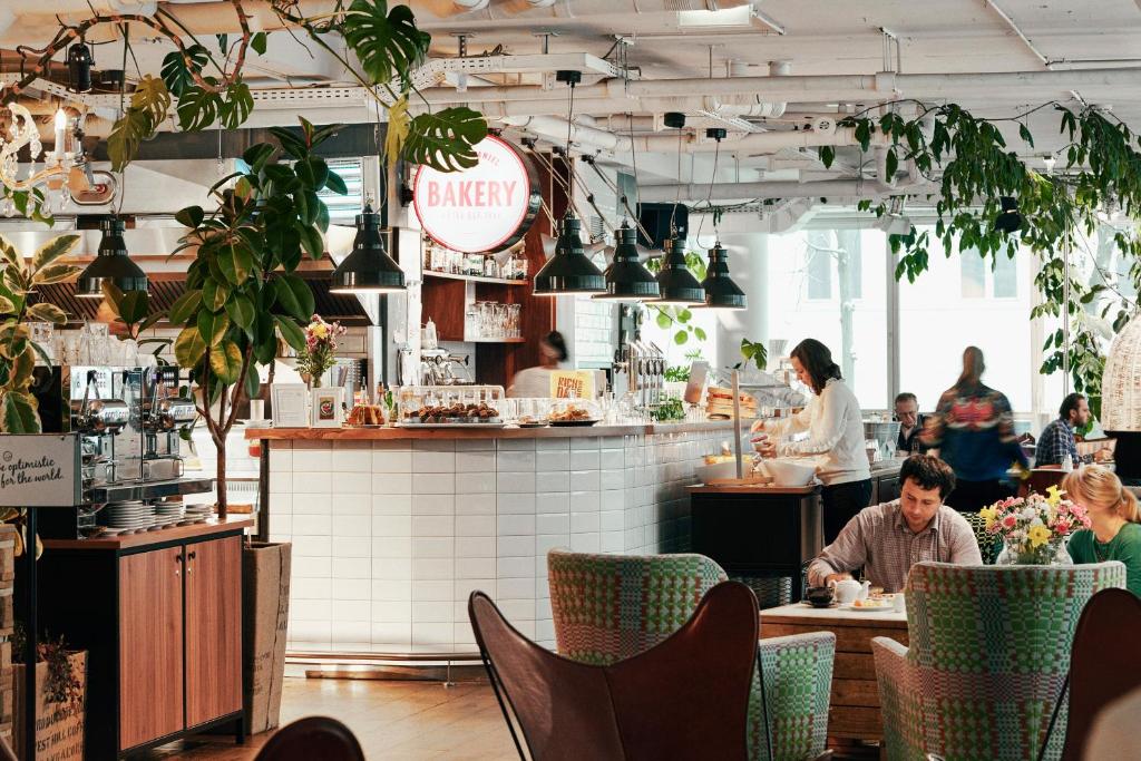 a man sitting at a table in a restaurant at Hotel Daniel Vienna - Smart Lifestyle Near City Centre in Vienna