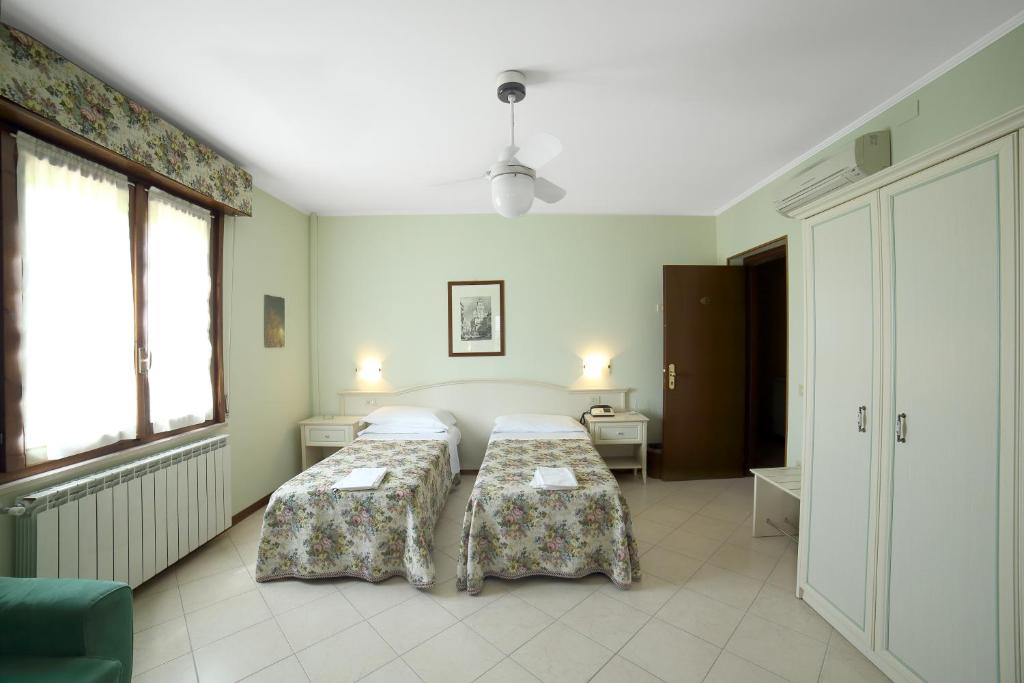 Postel nebo postele na pokoji v ubytování Albergo Il Gufo