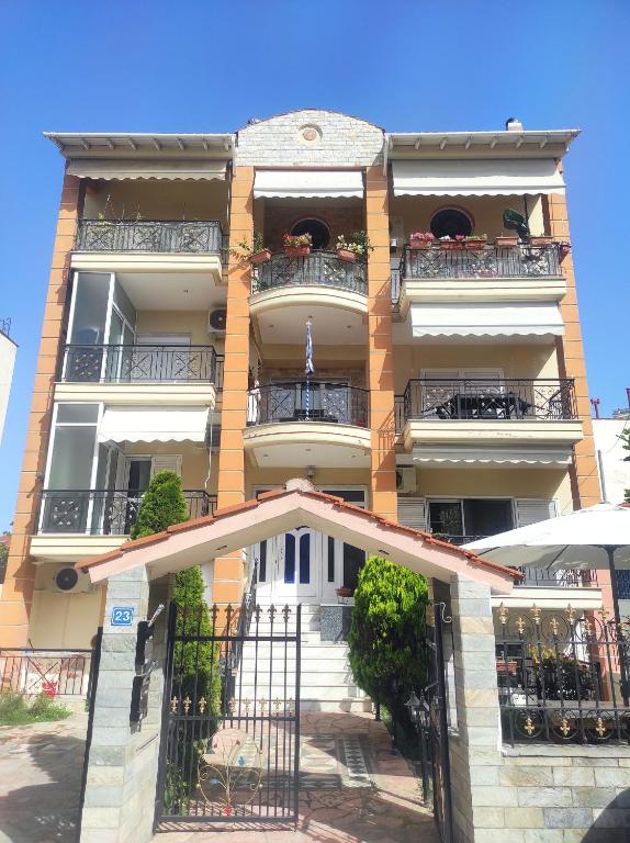 a large building with balconies and stairs in front of it at Ki &Ki apartments New Michaniona in Néa Michanióna