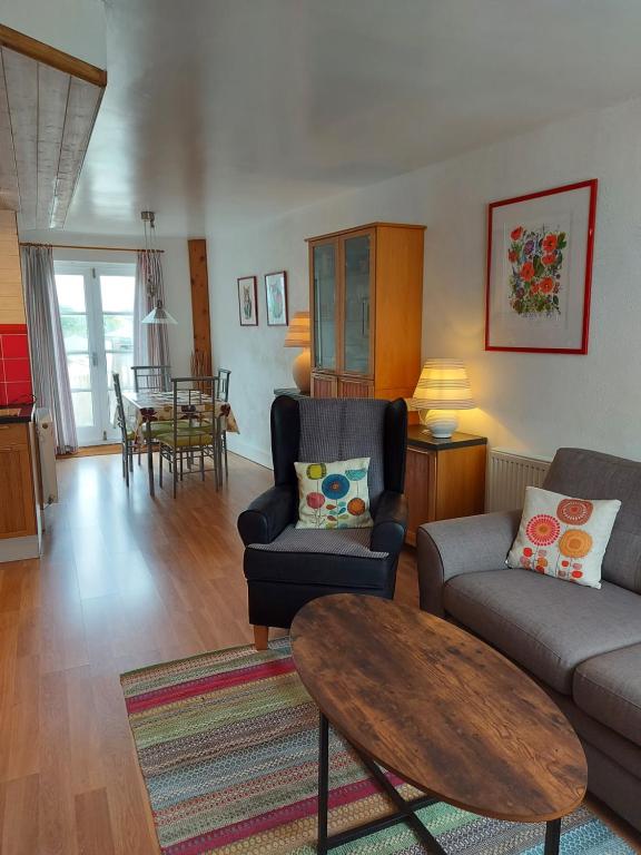 Fairholme Apartment في دارتموث: غرفة معيشة مع أريكة وطاولة