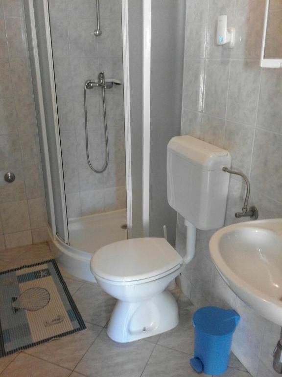 a bathroom with a toilet and a shower and a sink at Sea view room in Bol