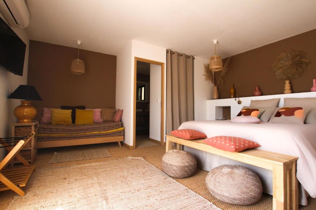a bedroom with a bed and a couch at Chambre d'hôtes A Vadina Porticcio in Porticcio