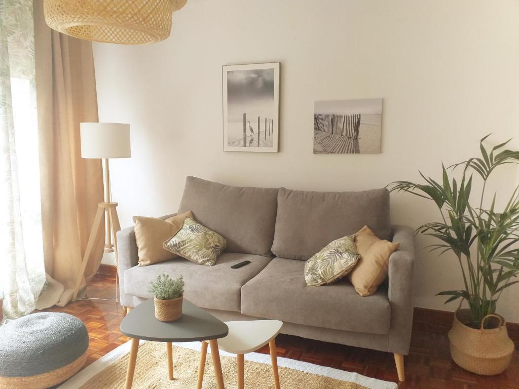 a living room with a couch and a table at Jovellanos Playa in Ribadesella