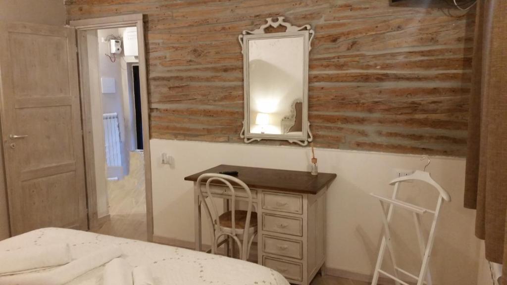 a bedroom with a wooden wall and a dresser and a mirror at La Bonbonnier in Venice