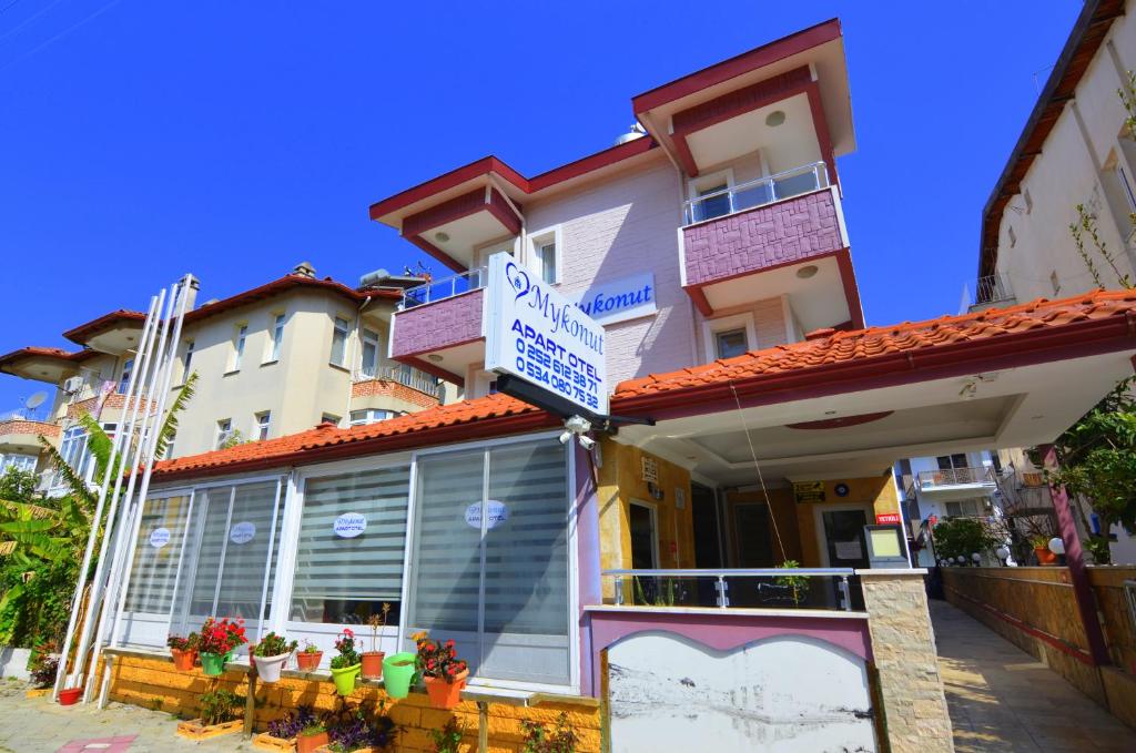 a building with a sign on the front of it at Mykonut Apart Hotel in Fethiye