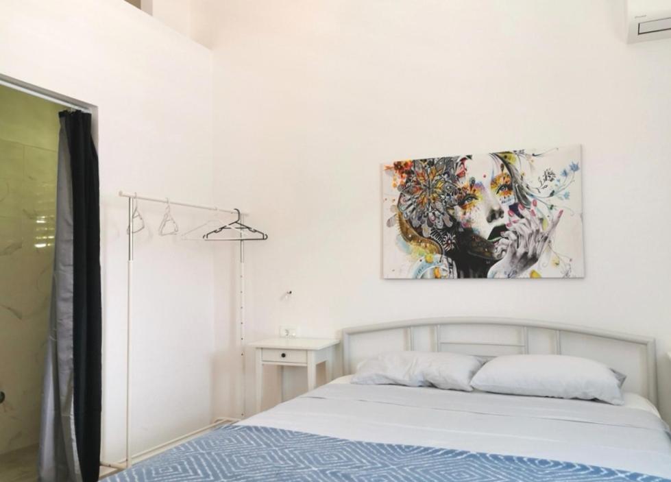 a bedroom with a bed and a painting on the wall at Vila Petra in Zaboric