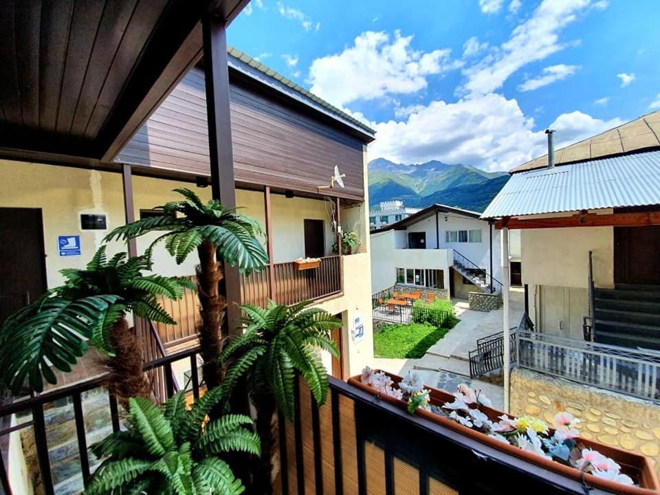 a balcony of a house with mountains in the background at Manoni Ratiani's Guesthouse in Mestia