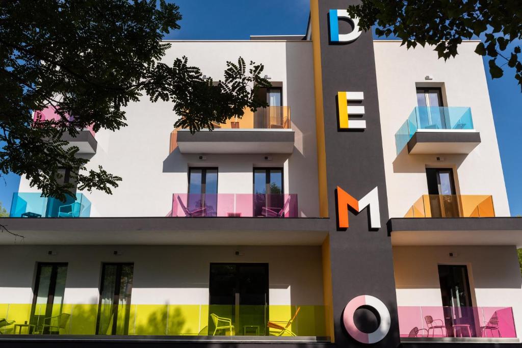 a building with colorful balconies on the side of it at Demo Hotel Design Emotion in Rimini