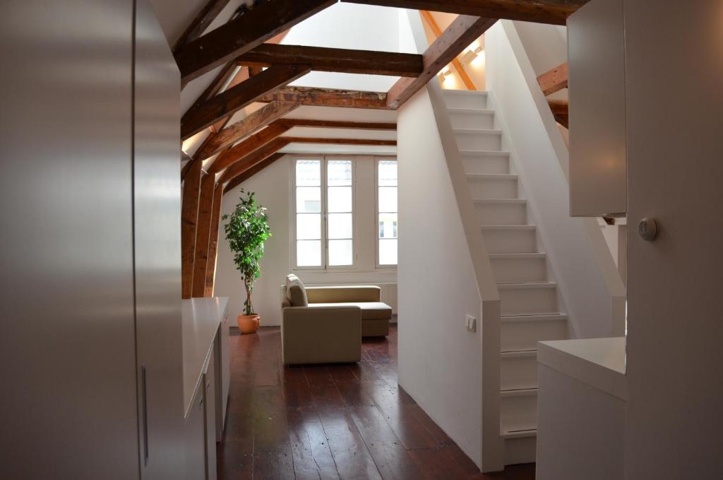 a hallway with a staircase and a living room at Rembrandtplein Bed & Breakfast in Amsterdam