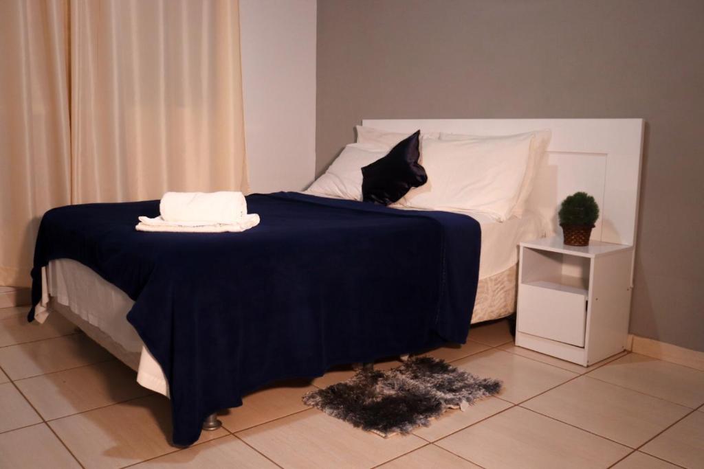 a bed with a black cat sitting on top of it at HOTEL RIO VERDE in Rio Verde