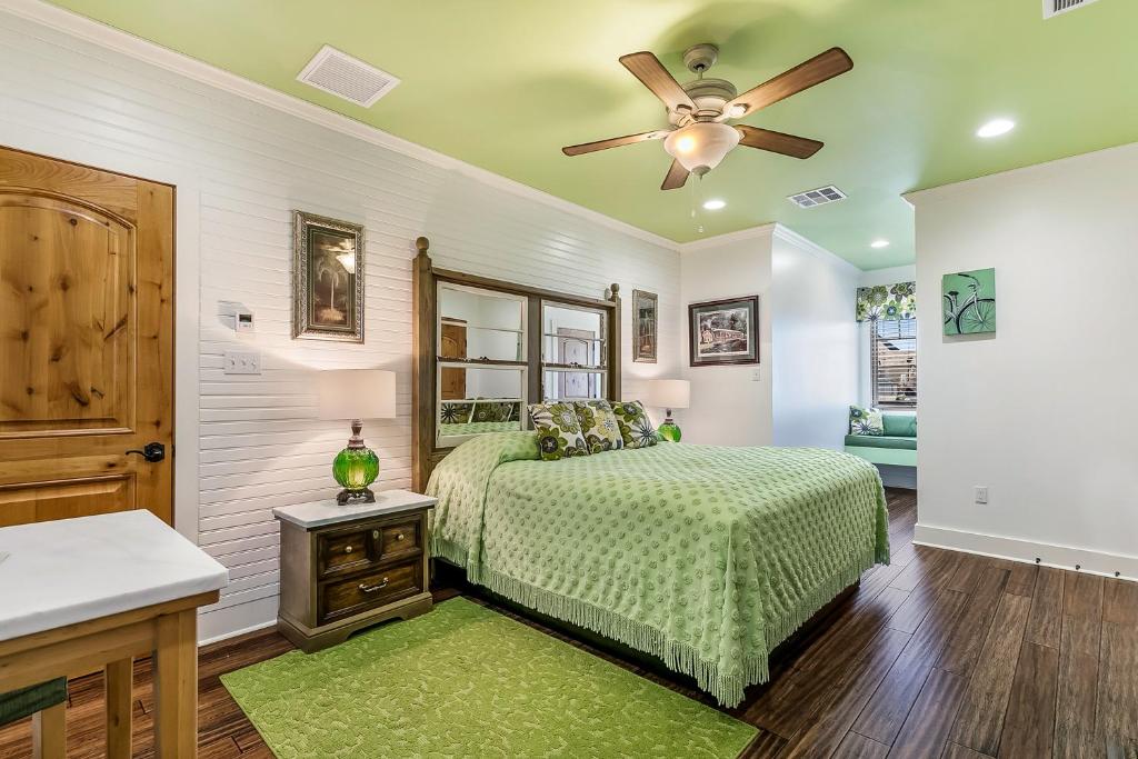a bedroom with a bed and a ceiling fan at de la Bleau B&B in Mandeville
