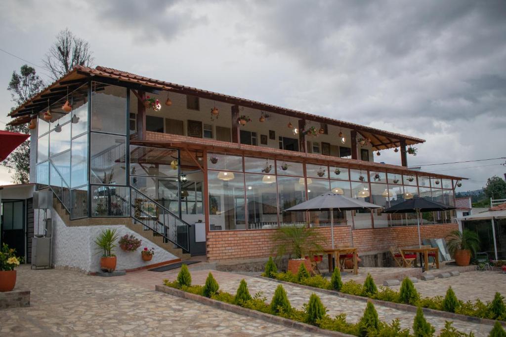 a building with a lot of windows on it at HOTEL BOUTIQUE 14 LANCEROS in Paipa