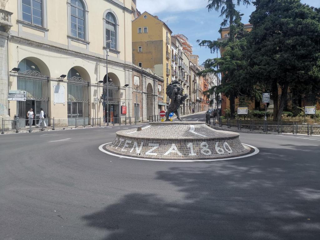 Une rue avec une statue au milieu de la rue dans l'établissement ESSENTIAL ROOM & PARKING in Centro Città con Parcheggio Privato e WIFI, à Potenza