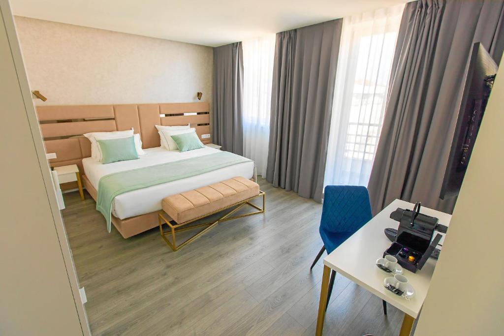 Postel nebo postele na pokoji v ubytování Hotel Mondego