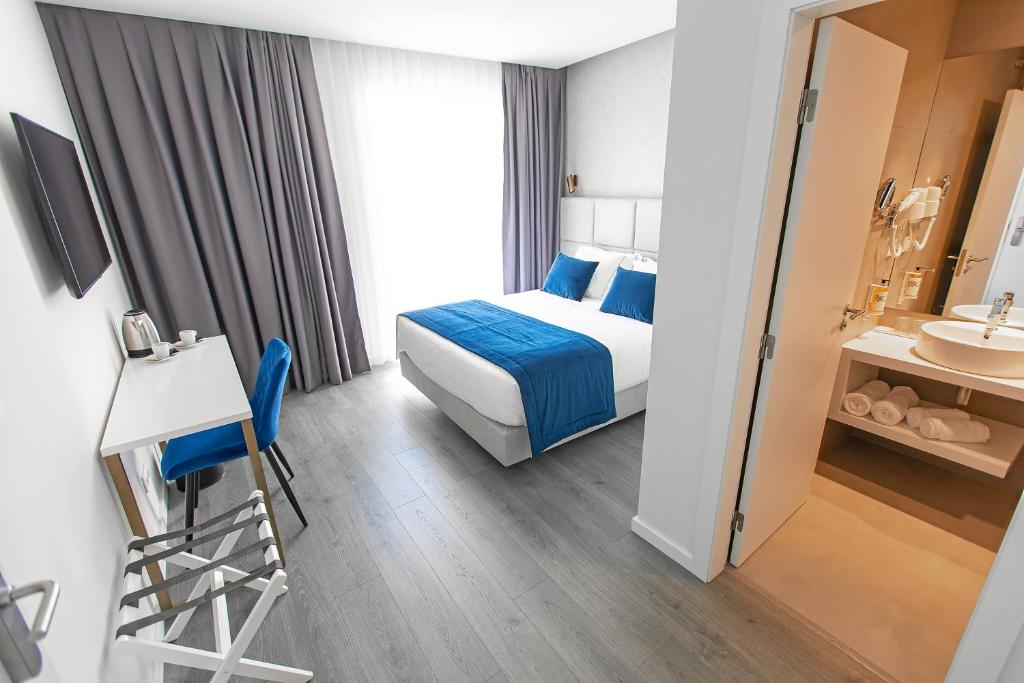 Postel nebo postele na pokoji v ubytování Hotel Mondego